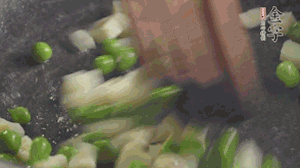 鍋中油7成熱時，入青豆、筍丁翻炒，然后加糯米飯加鹽均勻翻炒。