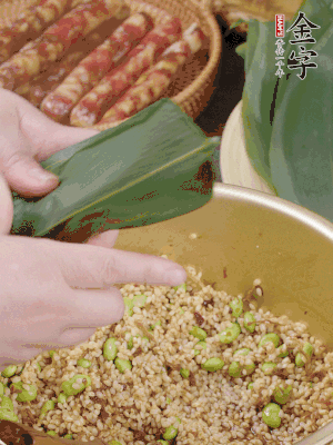 粽葉往下折，完全蓋住，兩側(cè)捏緊。